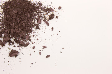 Fototapeta na wymiar This is a photograph of a Dark Purple powder Eyeshadow isolated on a White background
