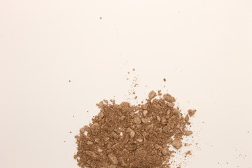 This is a photograph of a Copper powder Eyeshadow isolated on a White background