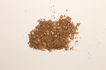 This is a photograph of a Copper powder Eyeshadow isolated on a White background
