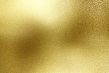 Brushed gold hard metal wall with scratched surface, abstract texture background