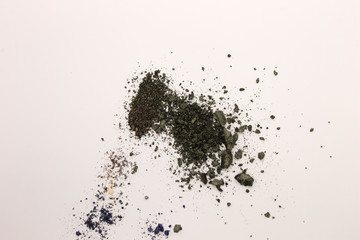 This is a photograph of Olive Green powder Eyeshadow isolated on a White background