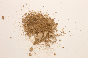 This is a photograph of pale Taupe powder Eyeshadow isolated on a White background