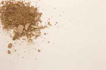 This is a photograph of pale Taupe powder Eyeshadow isolated on a White background