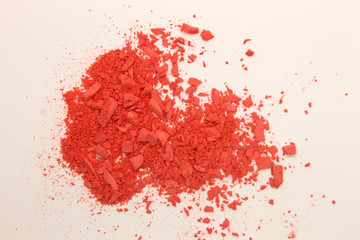 This is a photograph of Orange powder Blusher isolated on a White background