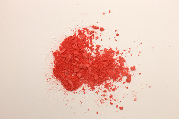 This is a photograph of Orange powder Blusher isolated on a White background