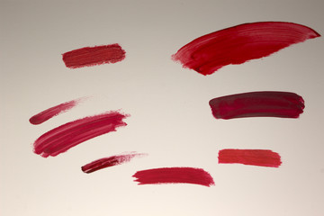 This is a photograph of Red Lipstick swatches isolated on a White background