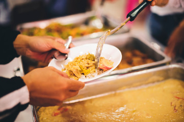 The hand of the poor receives food from the hand of the giver : concept of helping with feeding