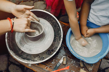 Potter make a small jug. Hands of a potter at work