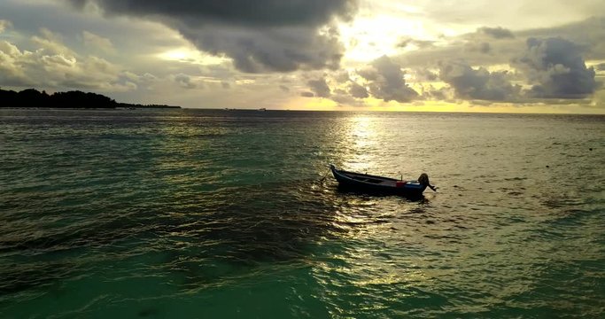 Yellow and green colors at sunset, fabulous seascape with an isolated boat near shore in Fuga island