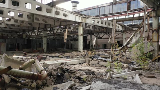 Abandoned Jupiter factory aerial drone inside view revolving around ruins