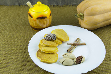 Pumpkin pancakes with pecans, powdered sugar and honey