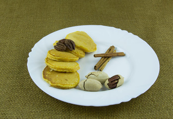 Pumpkin pancakes with pecans, powdered sugar and honey