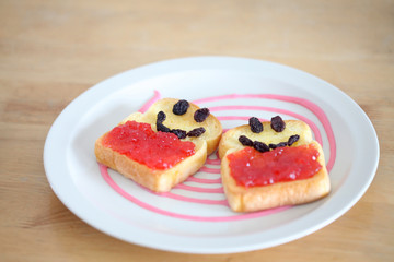 Toast and strawberry jam with currant , smile face toast