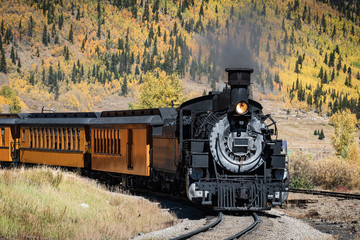 Fototapeta na wymiar Vintage Steam Train With Autumn Scenery Background.