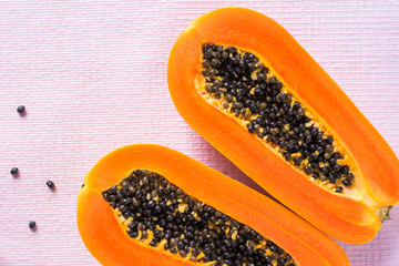 Papaya fruit on wooden background.Slices of sweet papaya on wooden background,Halved papayas