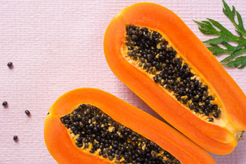 Papaya fruit on wooden background.Slices of sweet papaya on wooden background,Halved papayas