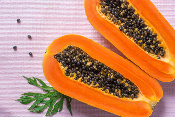 Papaya fruit on wooden background.Slices of sweet papaya on wooden background,Halved papayas