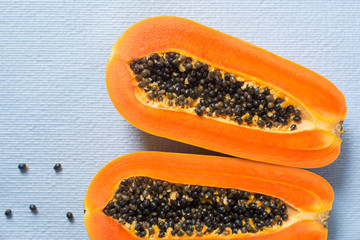 Papaya fruit on wooden background.Slices of sweet papaya on wooden background,Halved papayas