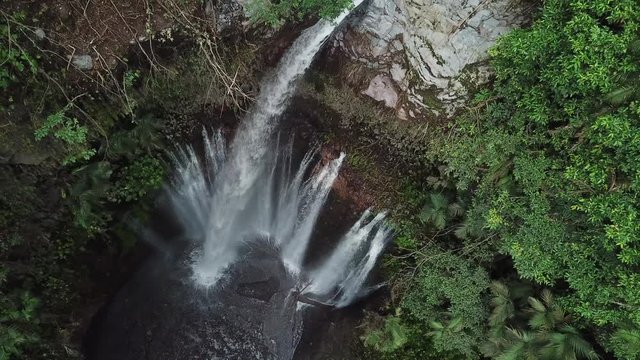 Tropical Paradise and Amazing Tiu Kelep Waterfall in Rainforest of Lombok Island Indonesia, Ascending Birdeye Aerial View