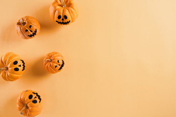 Top view of Halloween crafts, orange pumpkin on orange background with copy space for text. halloween concept.