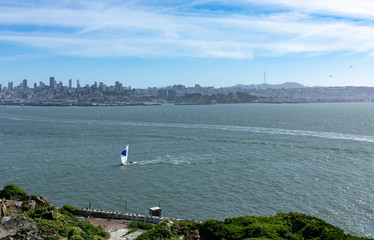 San Francisco Bay area, a saliboat and  Downtown San Francisco at the horizon