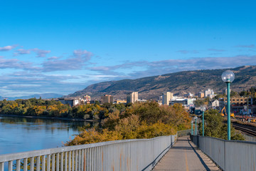 2019-10-03 Kamloops, BC, Canada. Riverside Park. View of Thompson River, Kamloops downtown buildings, mountains, trees.
