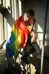 The struggle for their rights. Equality and freedom. Young attractive guy with a gay flag.