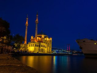 Ortakoy mosque and the bosphorus bridge at night in Istanbul, Turkey.