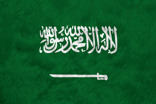 Towel fabric pattern flag of Saudi Arabia, a green field with the Shahada or Muslim creed written in the Thuluth script in white above a horizontal saber.