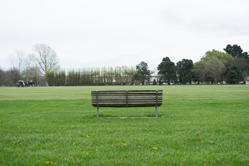 Empty wooden bench at the green park.Selective focus and copy space.