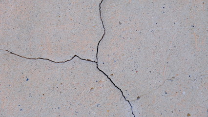 Fototapeta premium A crack on the concrete wall surface of a house in Los Angeles. Background image for your design