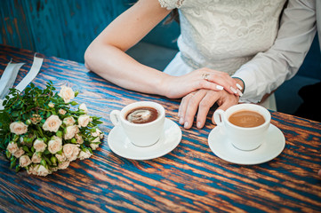 Obraz na płótnie Canvas Groom and bride with two cups of coffee