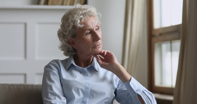 Serious thoughtful old woman looking away think of problem