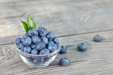 Blueberries in glass bowl on a wooden table