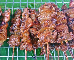 Roasted pork skewers for sale on the grill