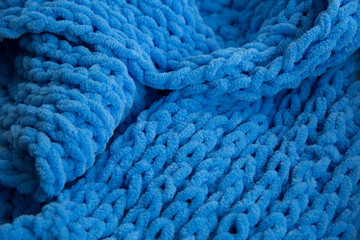 Set of blue knitted scarf fabric, large knitting, closeup.