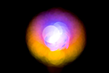 Abstract round blurred bokeh red yellow blue ball on a black background.