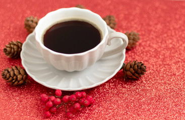 coffee, cones and mountain ash on Christmas red shiny background