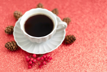 coffee, cones and mountain ash on Christmas red shiny background