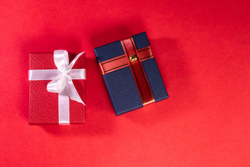Christmas gifts for  lovers with red and blue gift box with attractive  ribbons on red background
