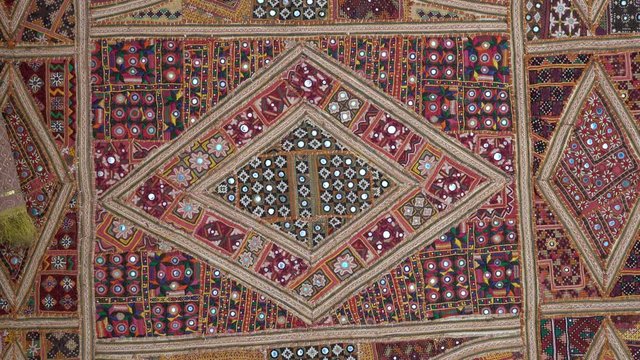 Detail old colorful patchwork carpet, establishing shot. Close up