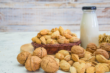 Arrangement of dried fruits almonds and walnuts on rustic old wooden table
