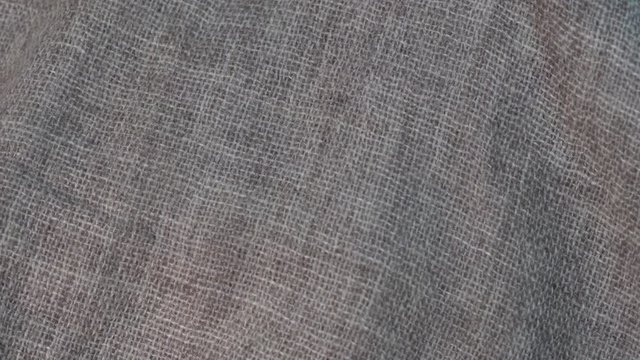 Crumpled textile texture as a background. Natural fabric linen texture for design. Close up, rotates