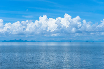 Naklejka na ściany i meble Blue sky background with white clouds on the lake.