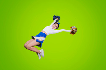 Low angle view of cheerleader jumps on studio