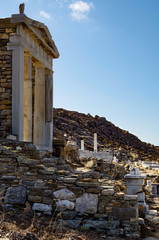Archeologic ancient and historic and temple ruins with columns and walls on museum island Delos...