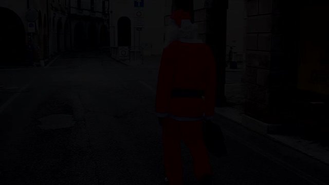 Santa Claus with his work bag walks in the city.