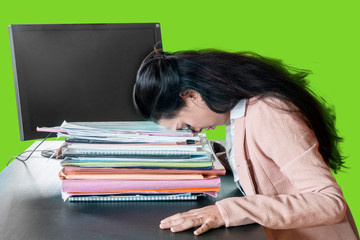 Stressful businesswoman sleeps above documents