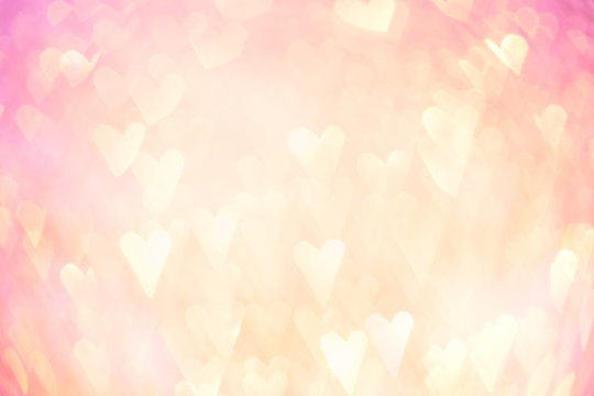 Abstract gold and red heart light bokeh holiday party background
