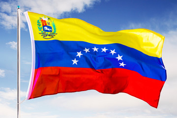 Venezuela national flag waving under blue sky
